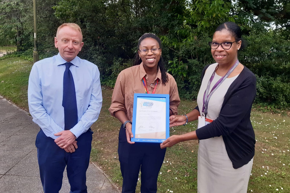 Iain Bancroft, Senior Vice President Electronic Warfare and Olyvia Jones Graduate Systems Engineer, formally receive a certificate from Carol Thomas of Luton Borough Council for the Luton Site’s Modeshift STARS Bronze Sustainable Travel Award