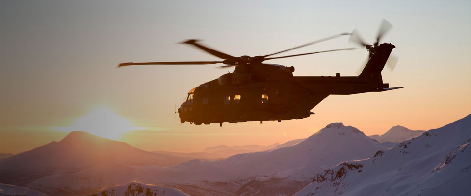 AW101 Merlin flies over mountains at sunset