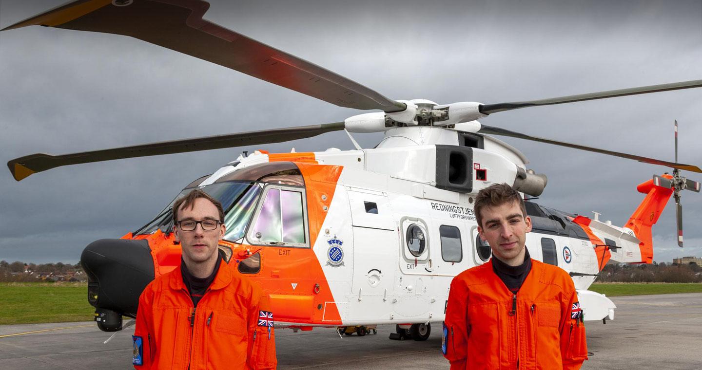 Flight Test Engineers Josh Sleeman and Ben Standen in front of a Norwegian AW101 Search and Rescue helicopter