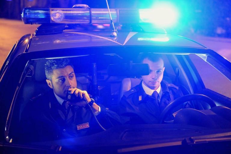 Two policeman in a car using critical communications equipment