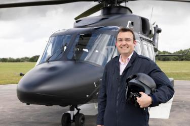 Leonardo Helicopters UK CEO Adam Clarke in front of an AW149
