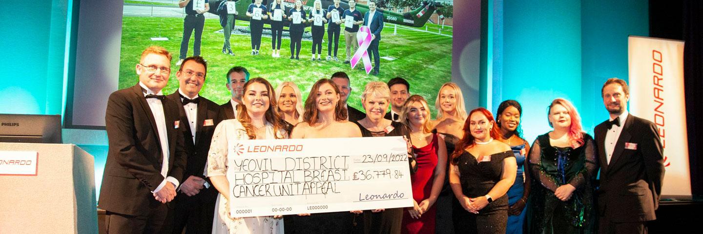 Employees holding a fundraising cheque for Yeovil Hospital Charity