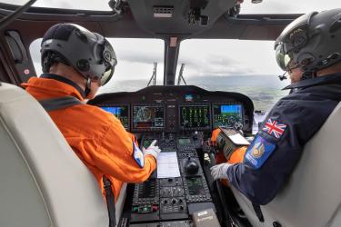 Helicopter test pilots in AW149 cockpit
