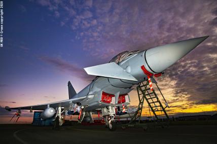 Typhoon shot at night, lit up and being prepared on the runway