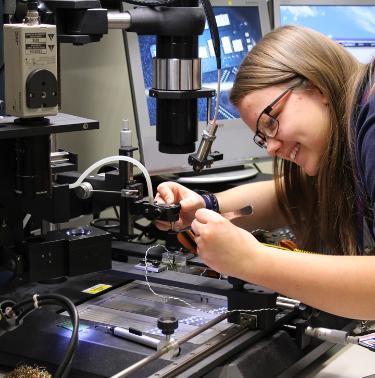 Basildon female apprentice working on printed circuit board