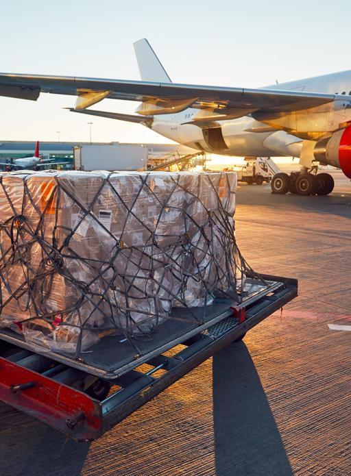 A large package is ready for loading onto airplane on tarmac