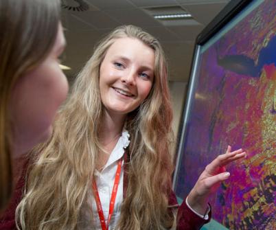 Girl points to screen with Thermal Imaging picture and smiles