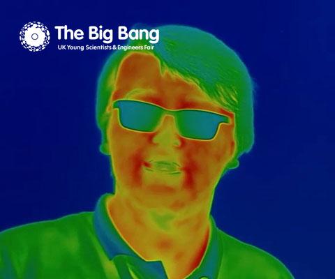Blue and orange Thermal Imaging photo of boy wearing glasses, with The Big Bang logo in top left corner