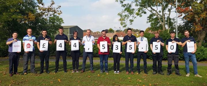 Apprentices and graduates hold up individual numbers to show fundraising total of over £44,000