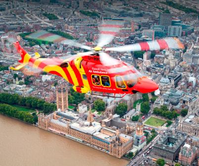 Essex and Herts AW169 air ambulance flying over the Houses of Parliament 