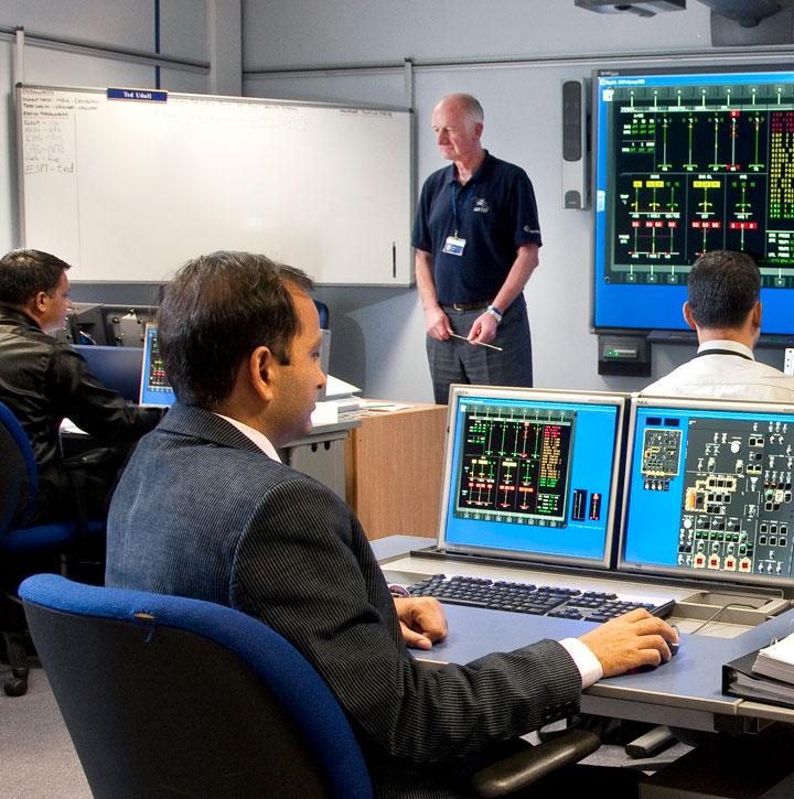 Students and trainer in a computer based training classroom at our Yeovil helicopter training academy