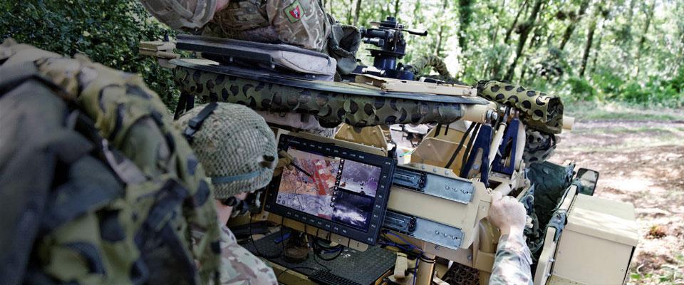 Army personnel looking at ruggised displays on-board an armoured vehicle
