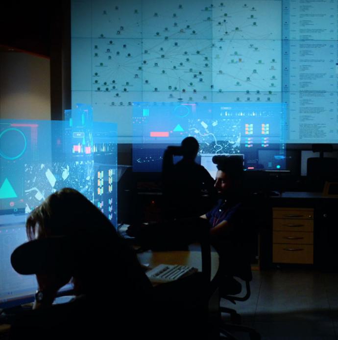 Artistic photo of security operations centre with data rich screens over superimposed over the top