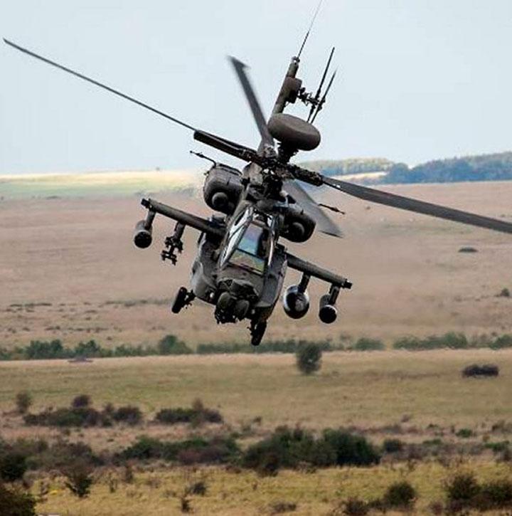 British Army Apache WAH-64 in flight over UK countryside